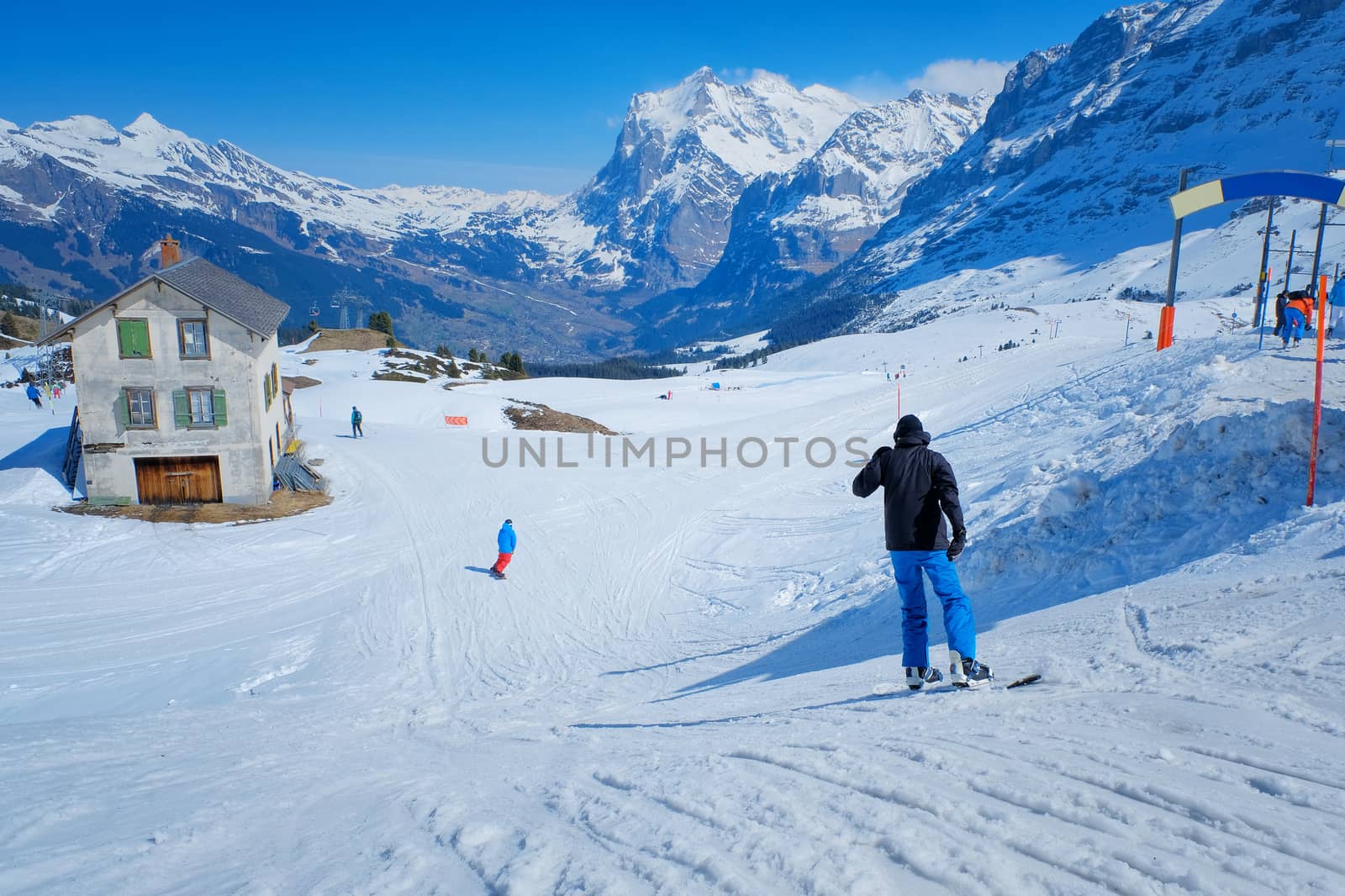 Skier skiing downhill in high mountains Kleine Scheidegg station by Surasak