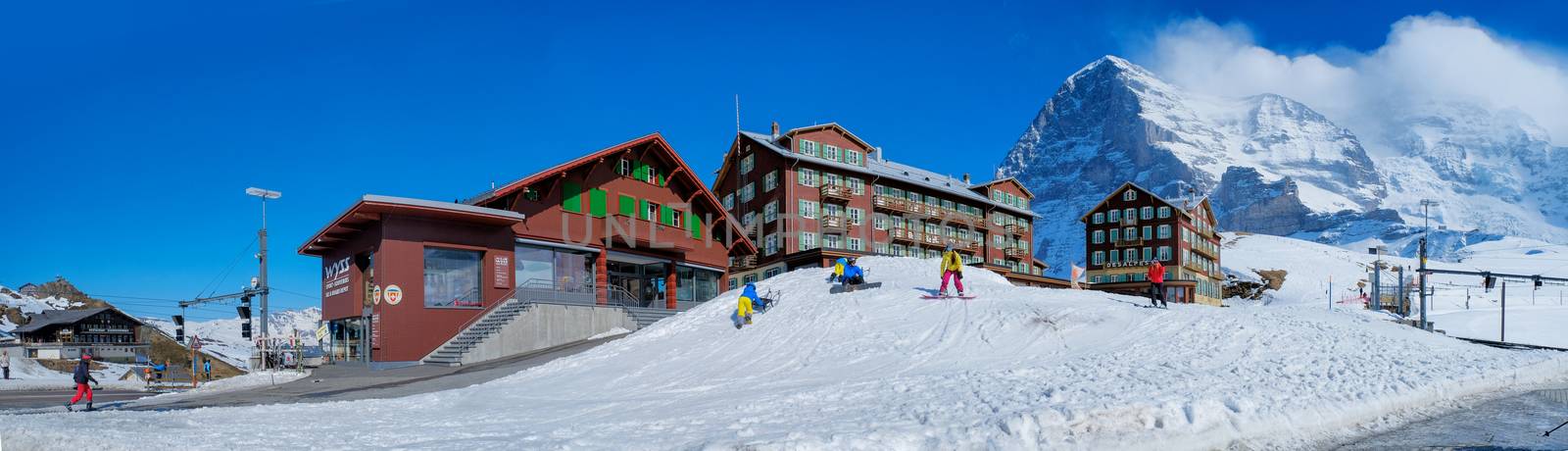 KLEINE SCHEIDEGG - 27 MARCH : Train and hotel at Kleine Scheidegg, Switzerland on March 27, 2017. Kleine Scheidegg is a famous mountain pass attracting many tourists come to playing ski each year.