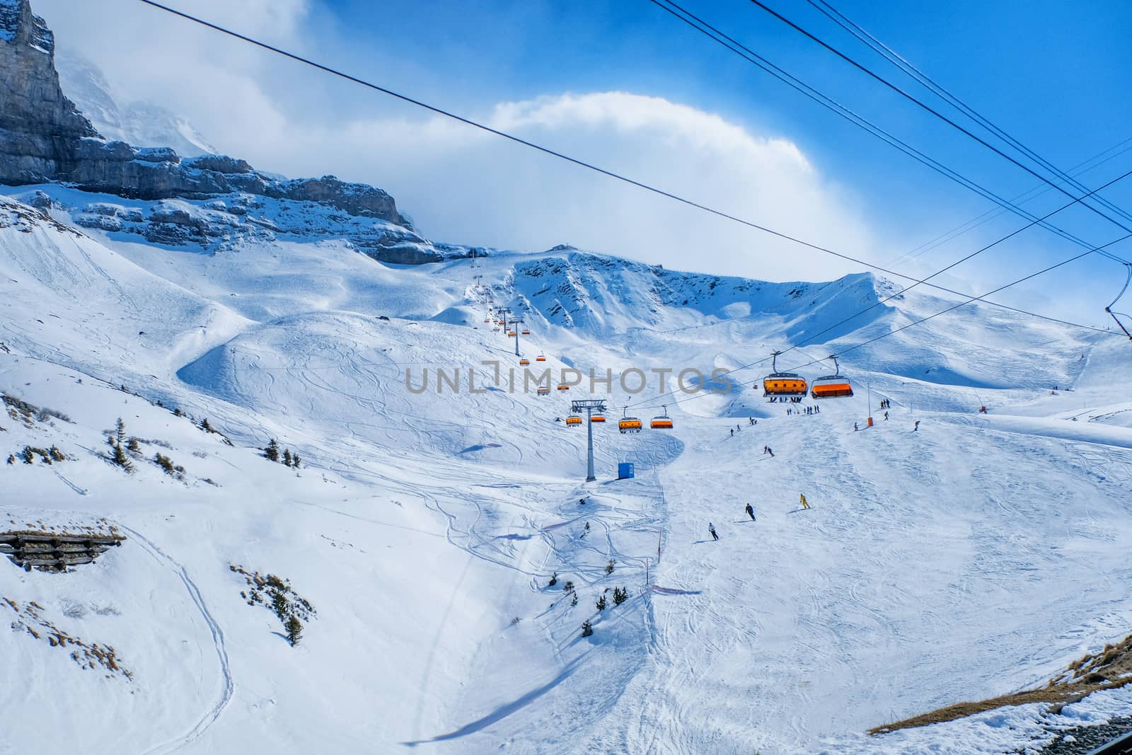 Panoramic view of ski chair lift in high mountains in Switzerlan by Surasak