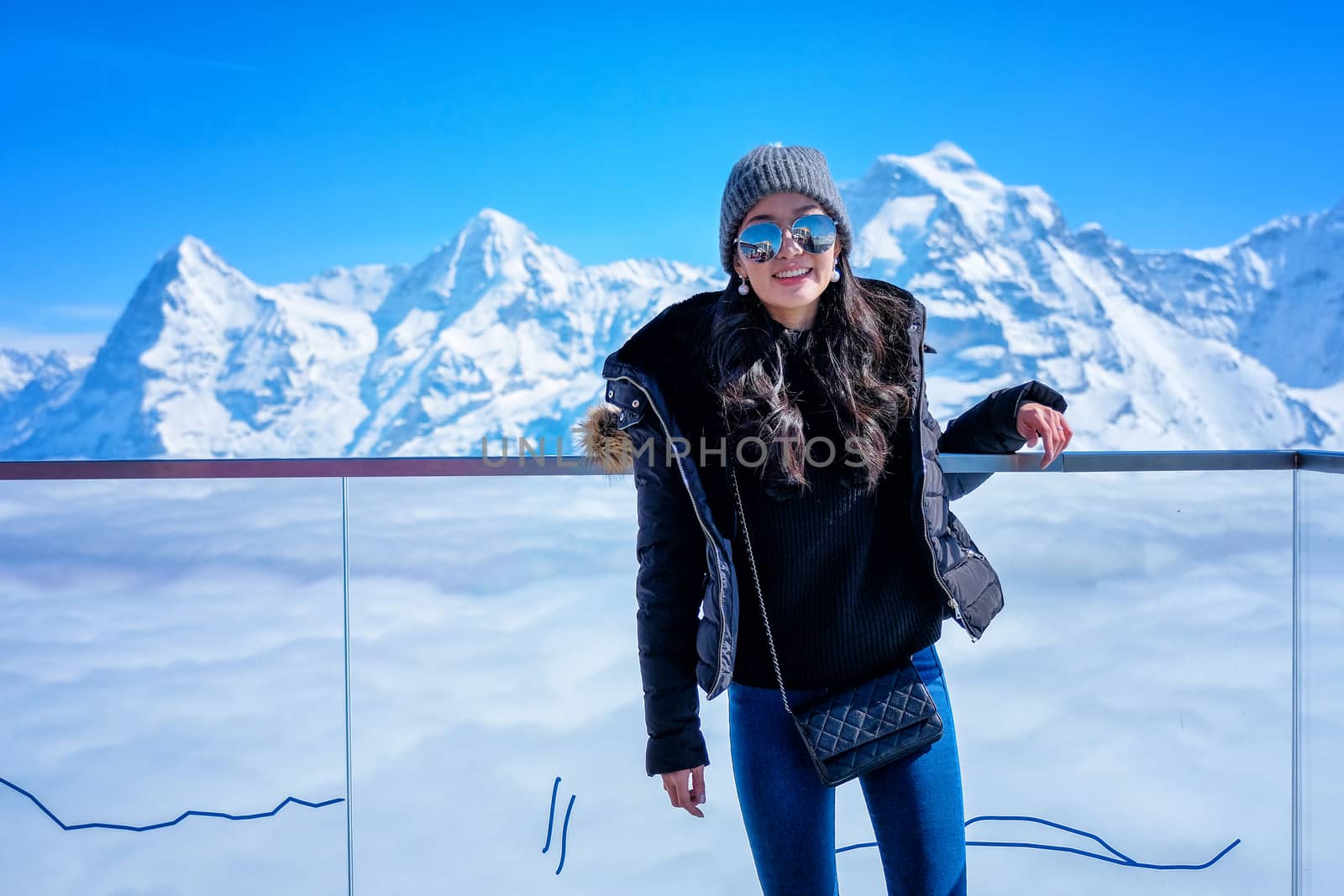 Young Woman Tourist at the Schilthorn in Switzerland with a magn by Surasak