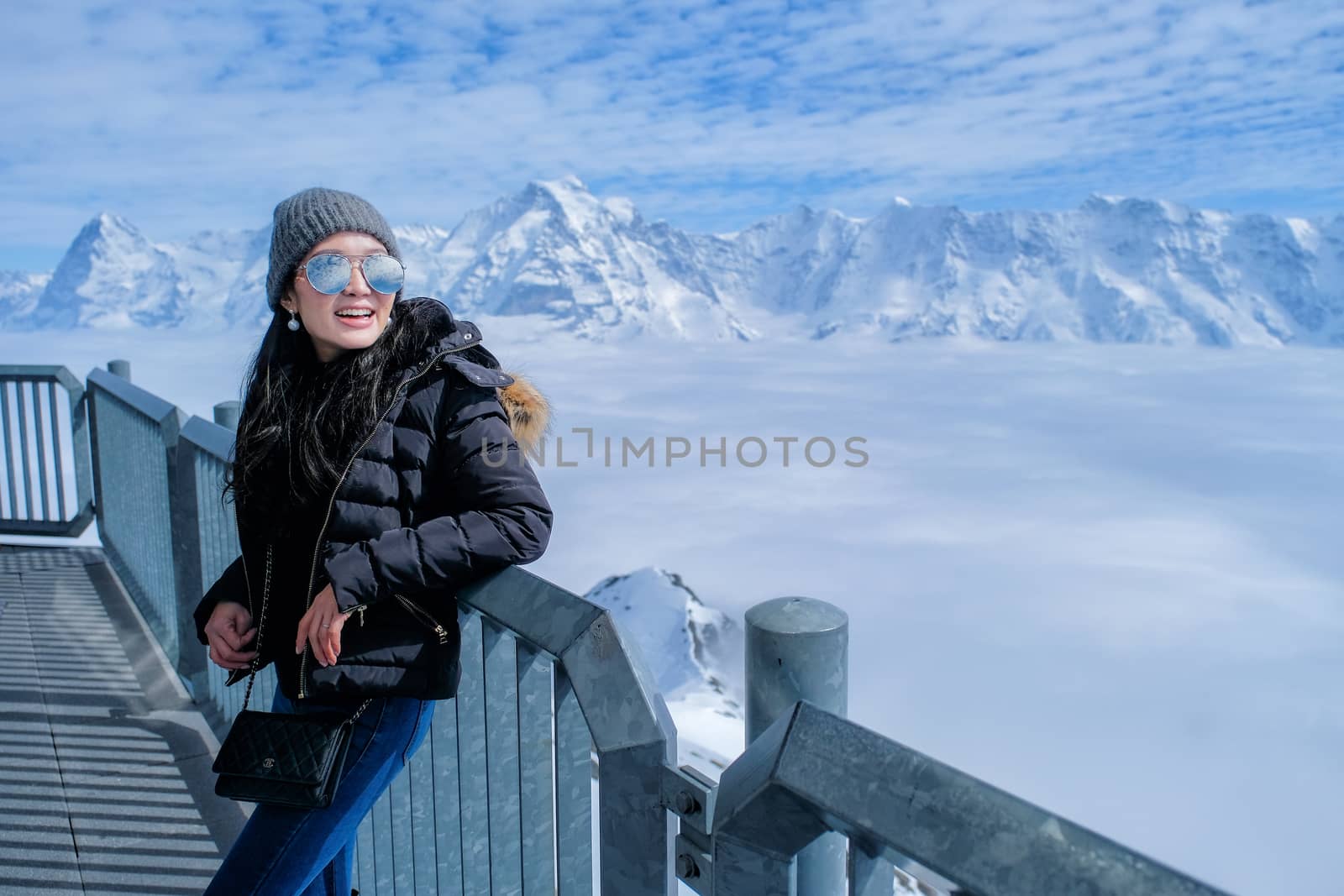 Young Woman Tourist at the Schilthorn in Switzerland with a magn by Surasak