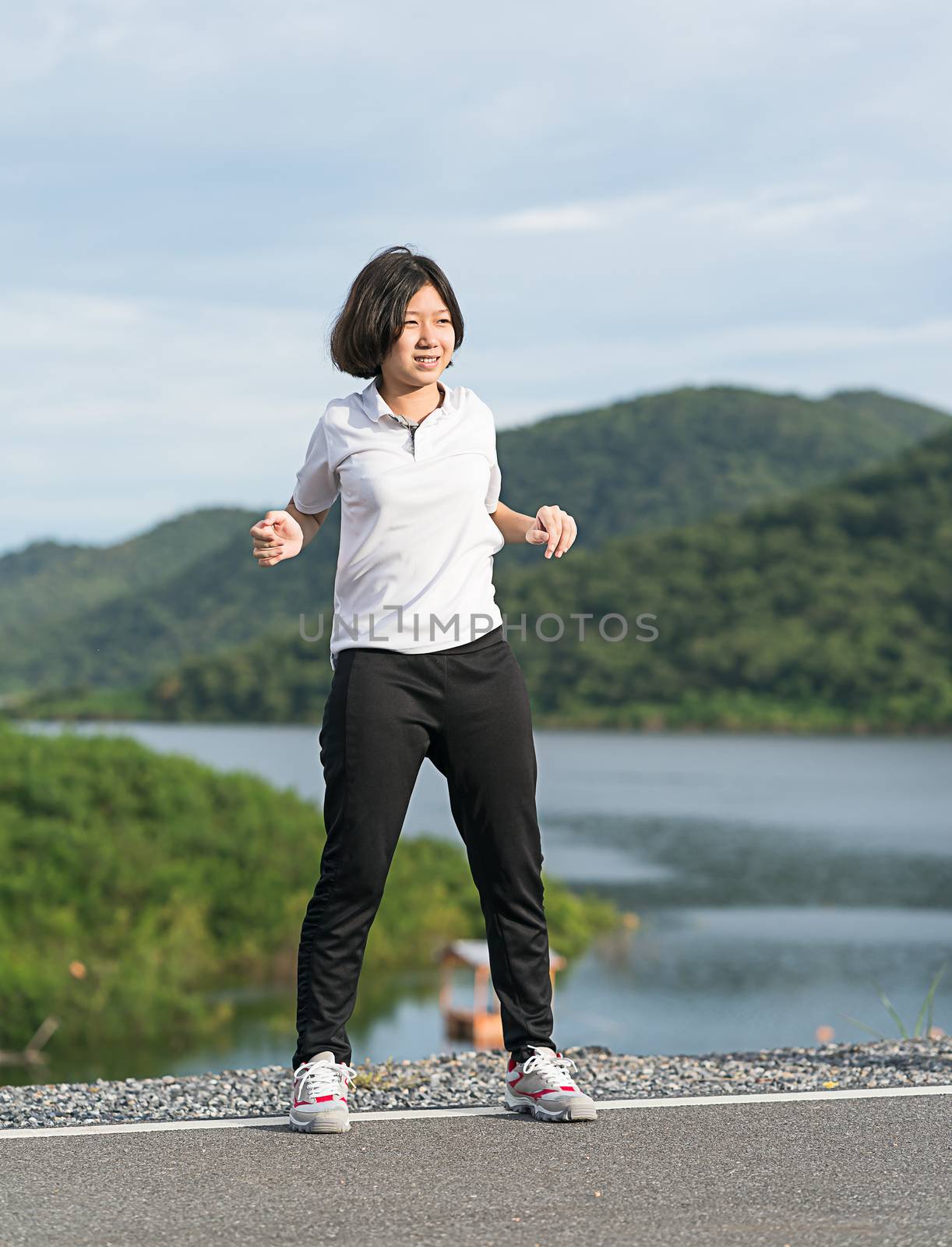 Woman short hair doing exercising outdoor by stoonn