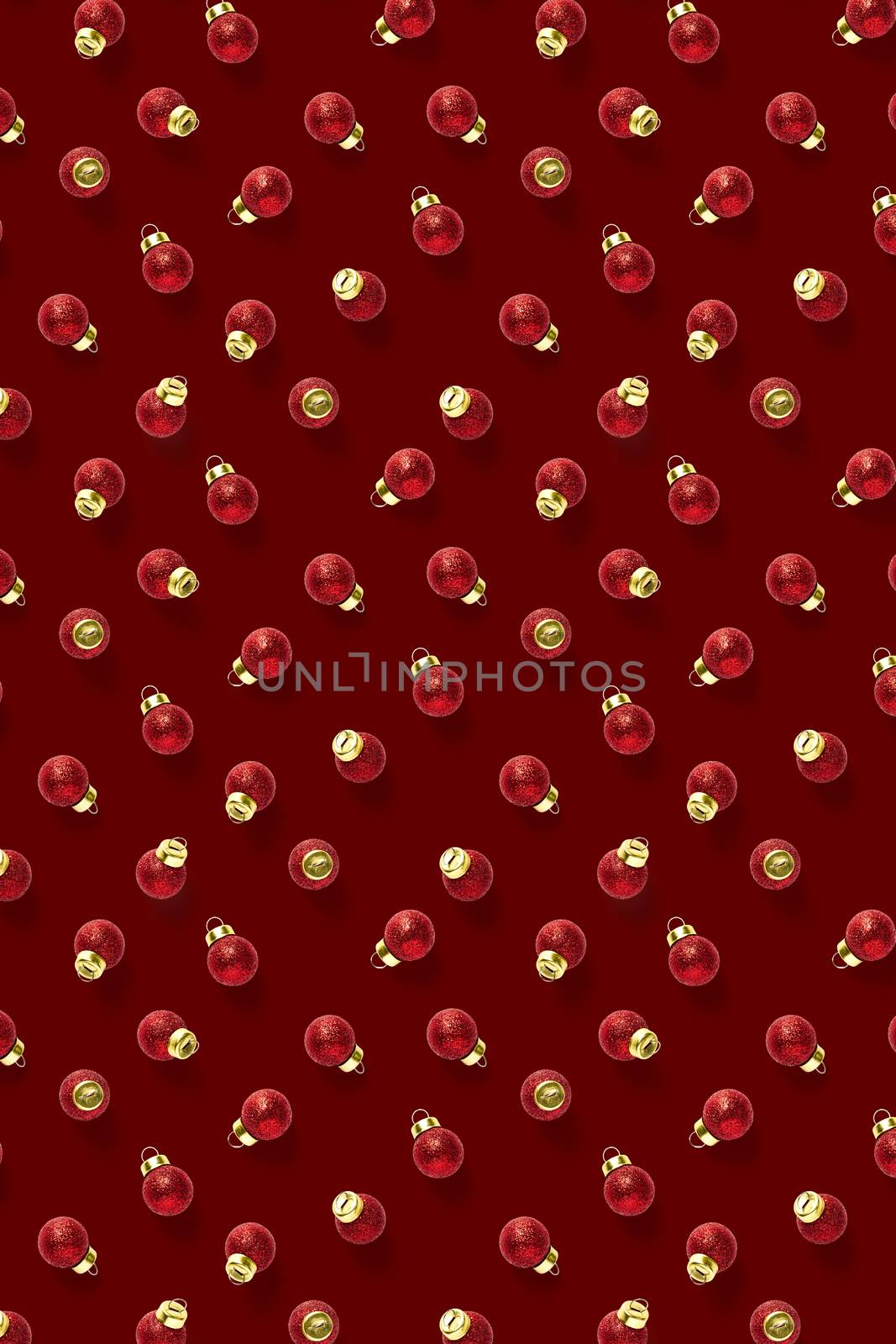 Christmas red decorations on dark red background. Christmas ornaments composition for background. Flat lay background madefrome red ornaments decorations