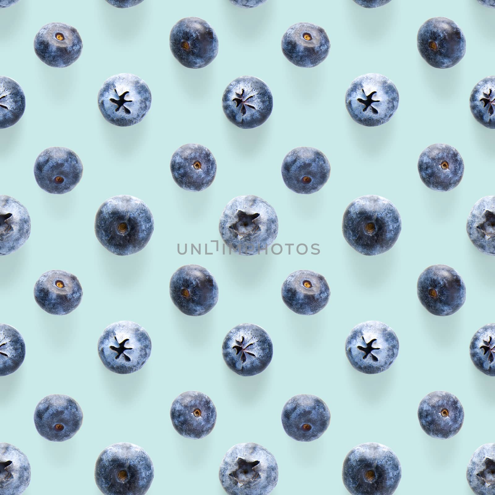 Trendy seamless pattern of blueberries. Blueberry pattern isolated on blue background. Blueberry flat lay, can be used for textile, prints, packing designs orother moden andcreative works