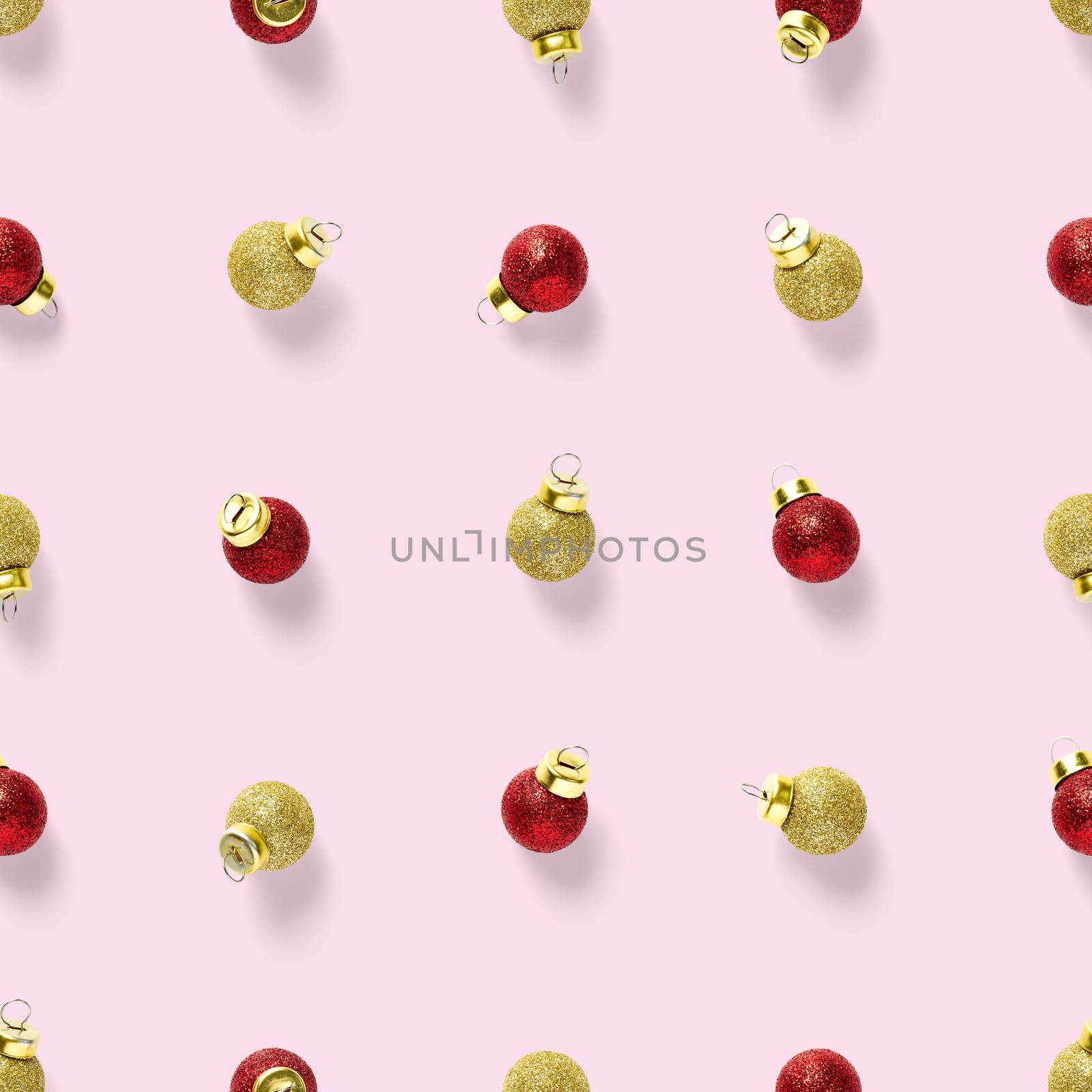 Seamless pattern with red and gold Christmas decorations on pink background. Christmas red ornaments Seamless pattern. Christmas abstract background made from balls.