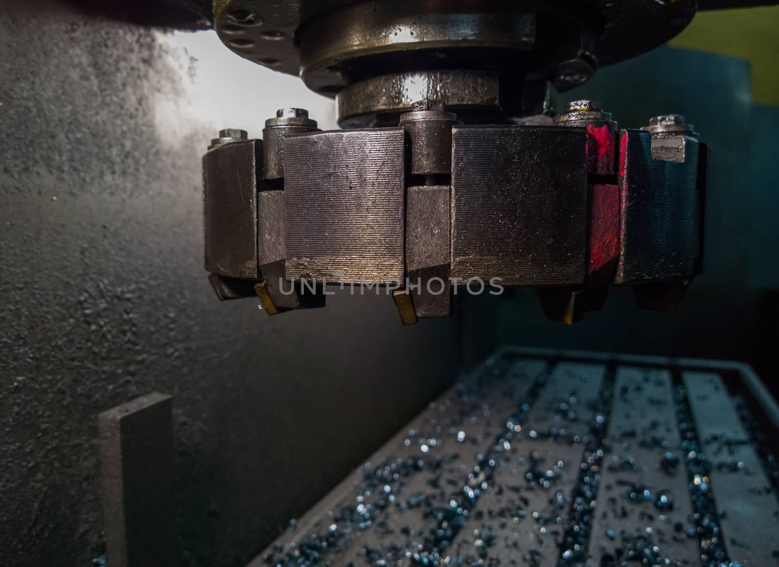 old manual milling machine shell mill in noir lighting style closeup with selective focus.