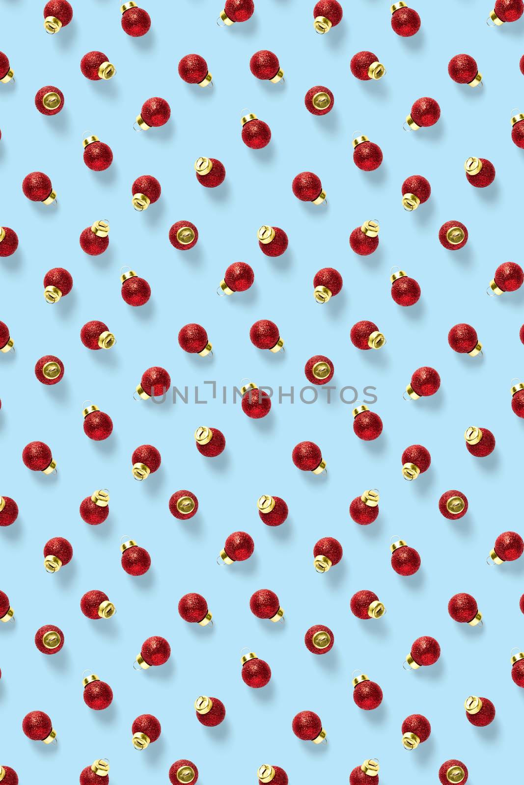 Christmas red decorations on blue background. Christmas ornaments composition for background. Flat lay background madefrome red ornaments decorations