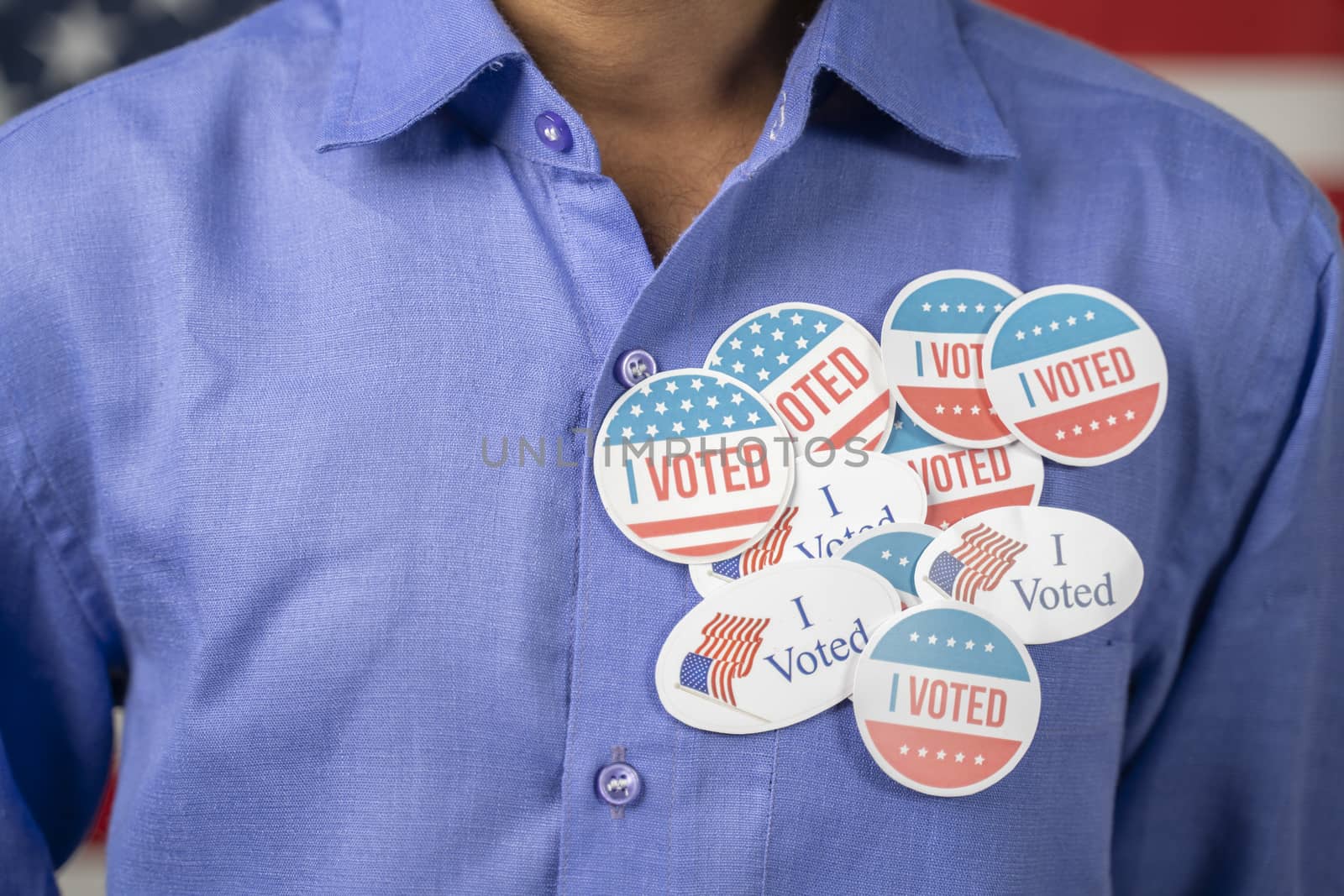 Close up of multiple I Voted stickers on blue shirt - Concept of US election voter fraud by placing multiple voting stickers by lakshmiprasad.maski@gmai.com