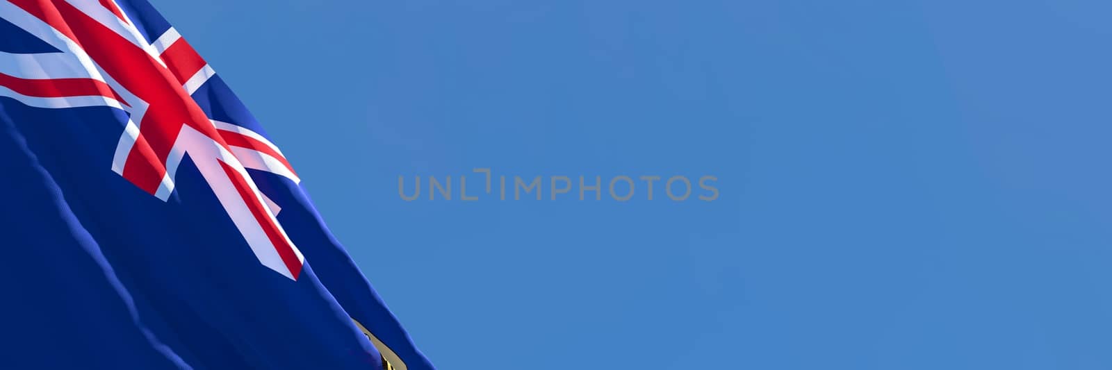 3D rendering of the national flag of Saint Helena waving in the wind against a blue sky