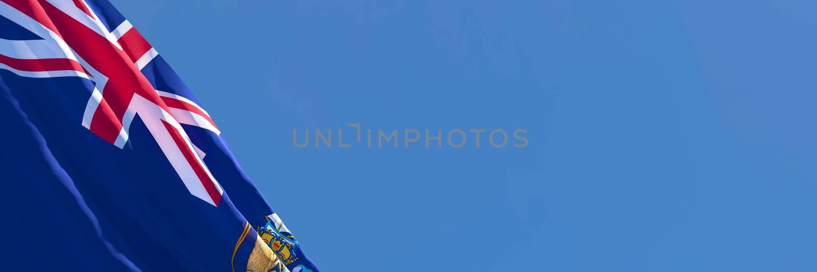 3D rendering of the national flag of Tristan da Cunha waving in the wind against a blue sky