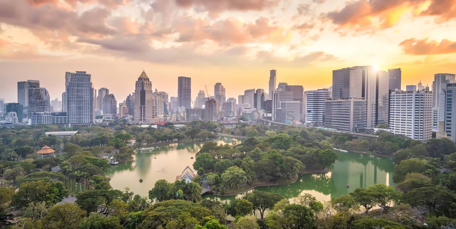 Downtown Bangkok city skyline with Lumpini park from top view in Thailand at sunset