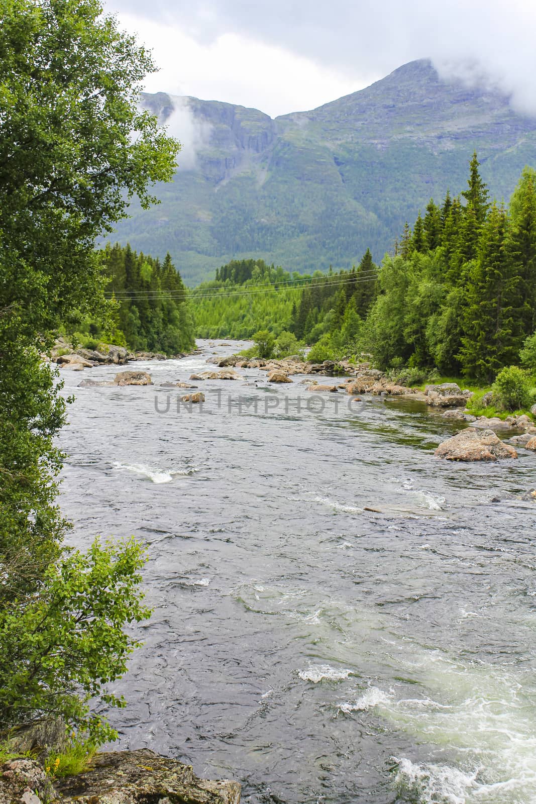 Flowing beautiful turquoise river lake with stones in Ulsåk, Hemsedal, Viken, Buskerud, Norway.