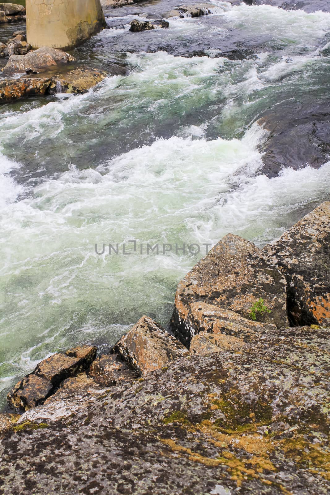 Flowing beautiful turquoise river lake with stones in Ulsåk, Norway. by Arkadij