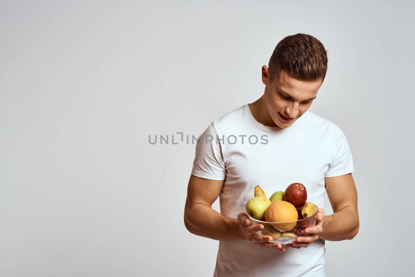 Man with fresh fruit in a cup health lifestyle healthy nutrition vitamins by SHOTPRIME
