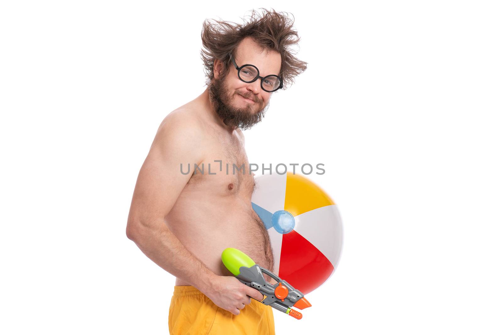 Crazy bearded Man with funny Haircut in eye Glasses, ready for fun at sunny beach. Happy and silly tourist, isolated on white background. Cheerful naked man holding Water Gun and Sea Ball.