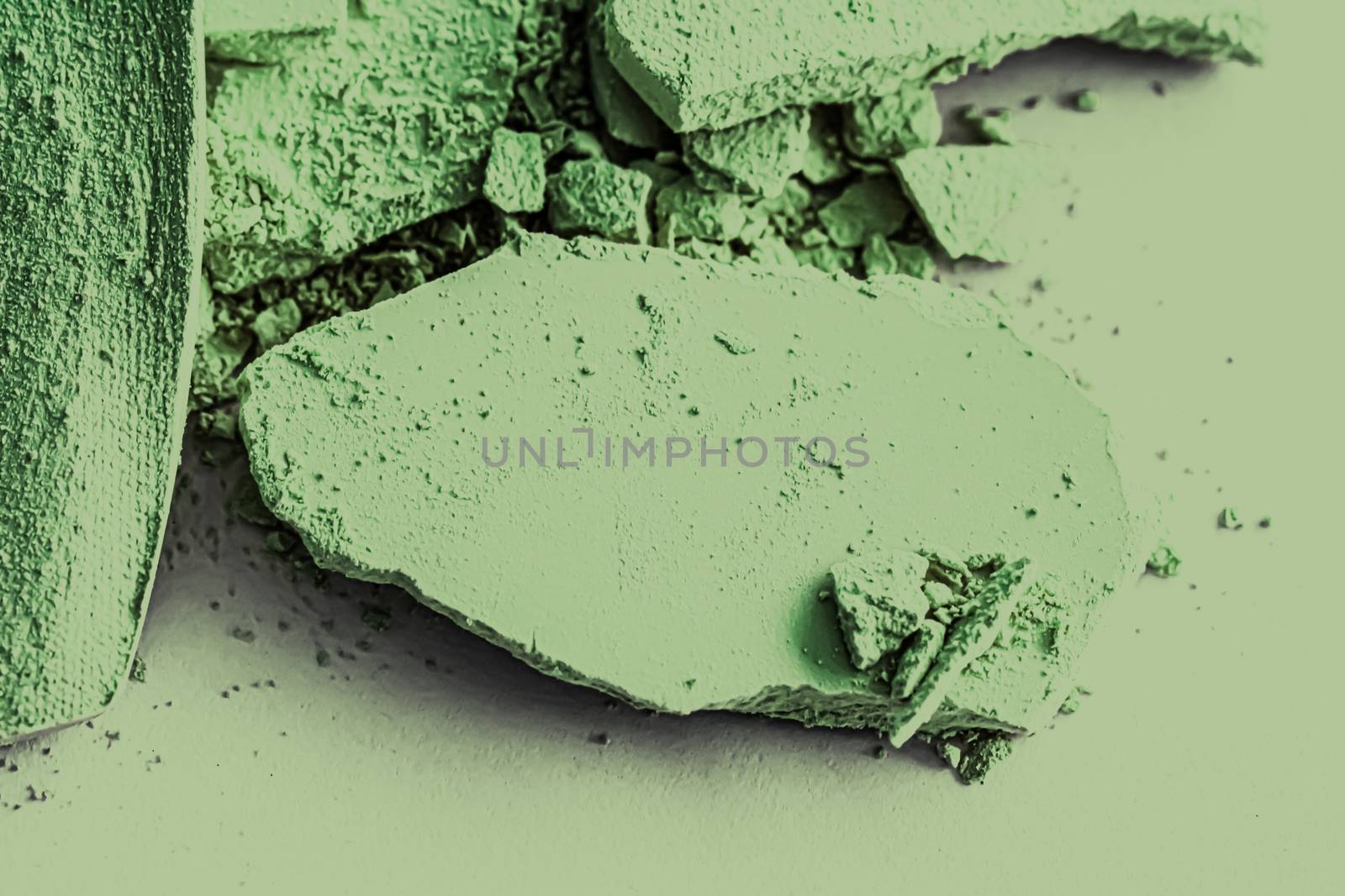 Green eye shadow powder as makeup palette closeup, crushed cosmetics and beauty textures