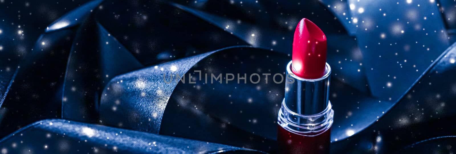 Red lipstick on blue silk and shiny glitter background, luxury make-up and beauty cosmetics