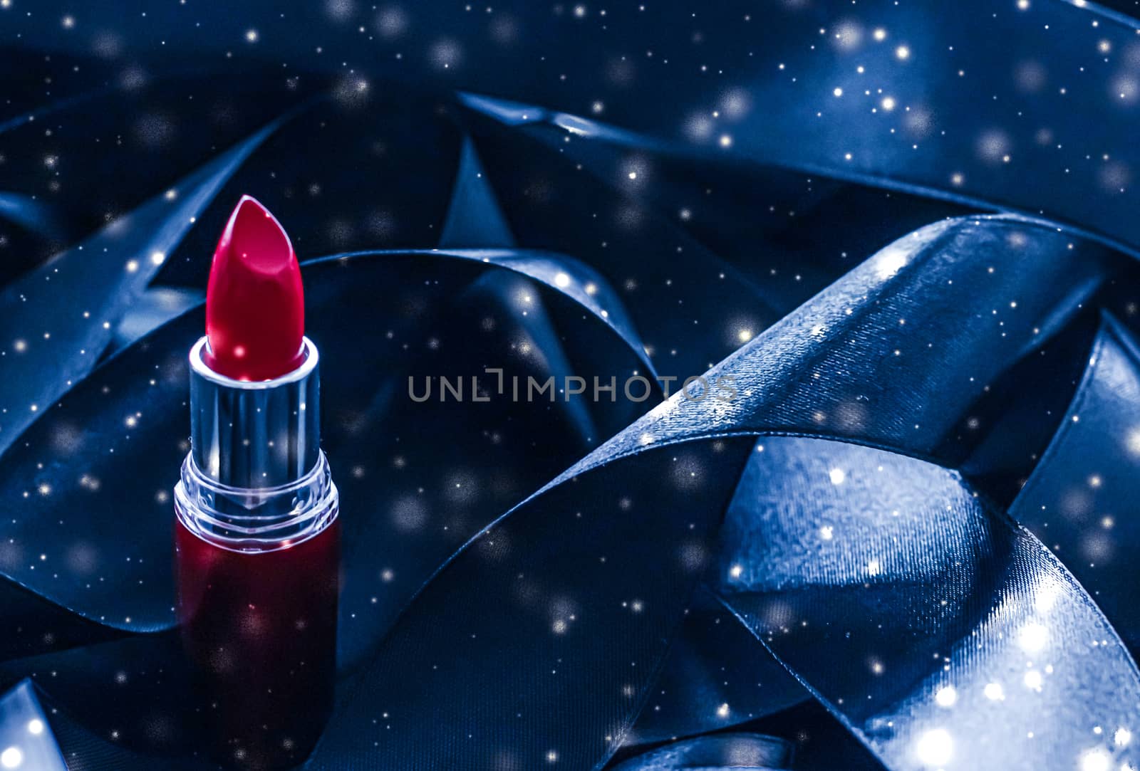 Red lipstick on blue silk and shiny glitter background, luxury make-up and beauty cosmetics