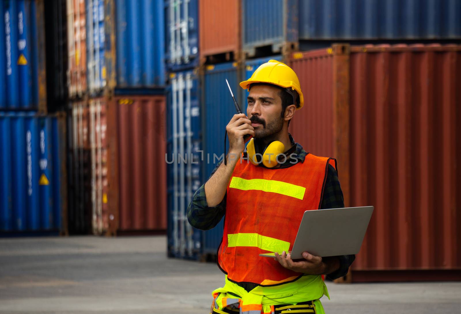 industrial worker is controlling container loading in import-exp by pkproject