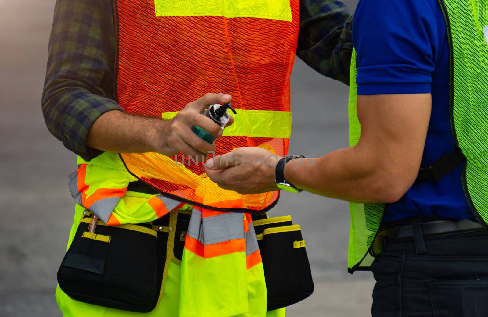 Workers wash their hands with alcohol gel before entering the wo by pkproject