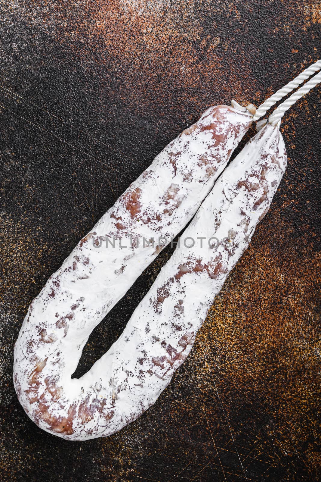 Spanish salami fuet wurst on old metall background.