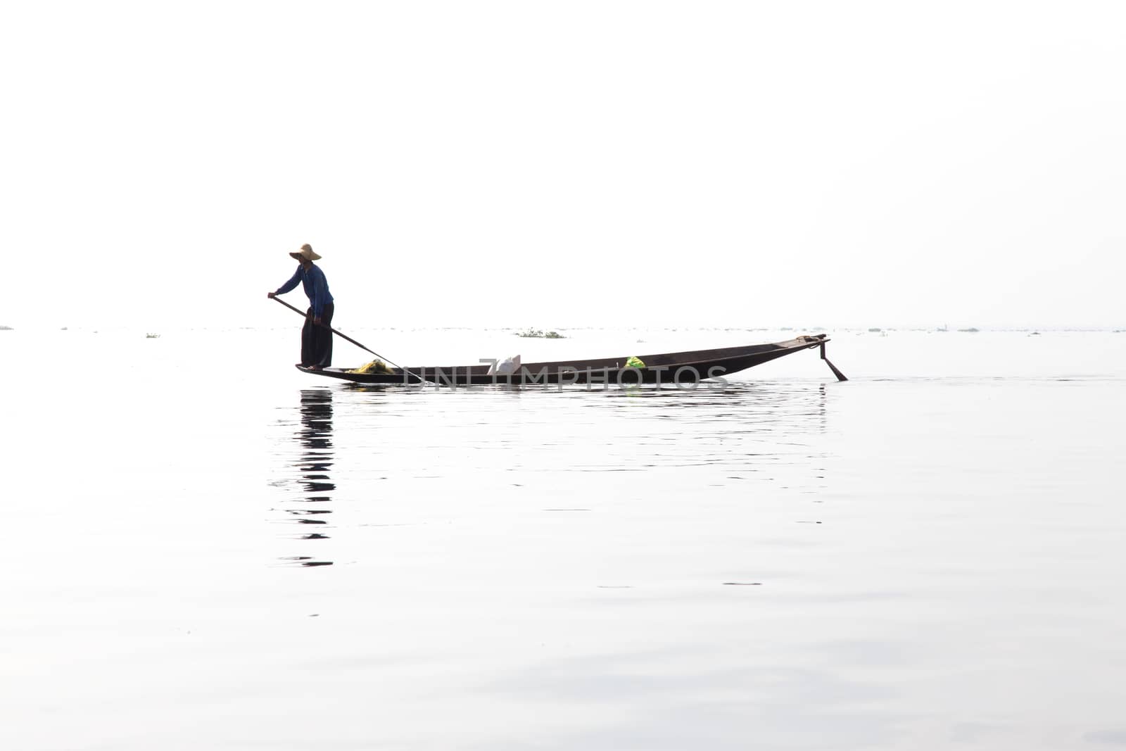 Inle Lake, Myanmar 12/16/2015 traditional Intha fisherman rowing with one leg by kgboxford