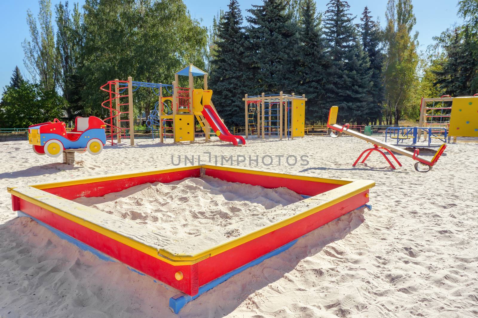 Empty playground in sunny day. Playground for toddlers and kids with nobody there. Kindergarten, primary school playground background. Nobody on playground. Ground outdoor. Quarantine and children by synel