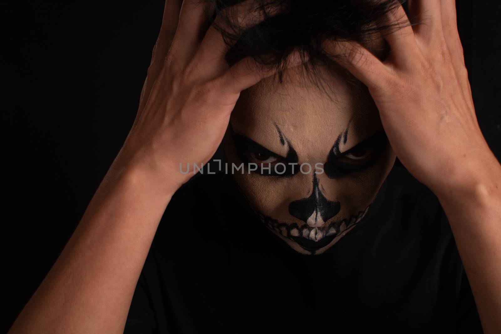 Southeast asian man with skull face makeup on black background by cuckoo_111