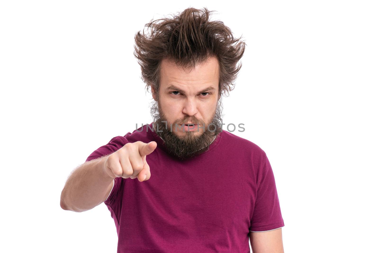 Crazy bearded Man with funny Haircut points his finger at you. Serious Guy looking at camera and pointing to the front, isolated on white background. Emotions and signs concept.