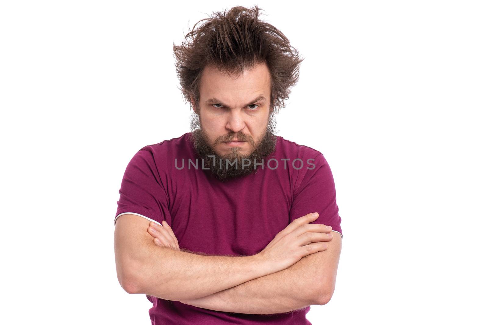 Crazy serious bearded man with confident or displeased expression, keeps arms folded, isolated on white background. Guy with funny Haircut looking in camera with anger. Emotions and signs concept.