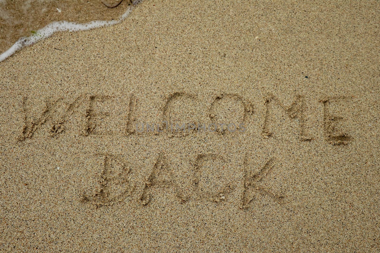 welcome back, text on sand beach, tourism after pandemic concept.