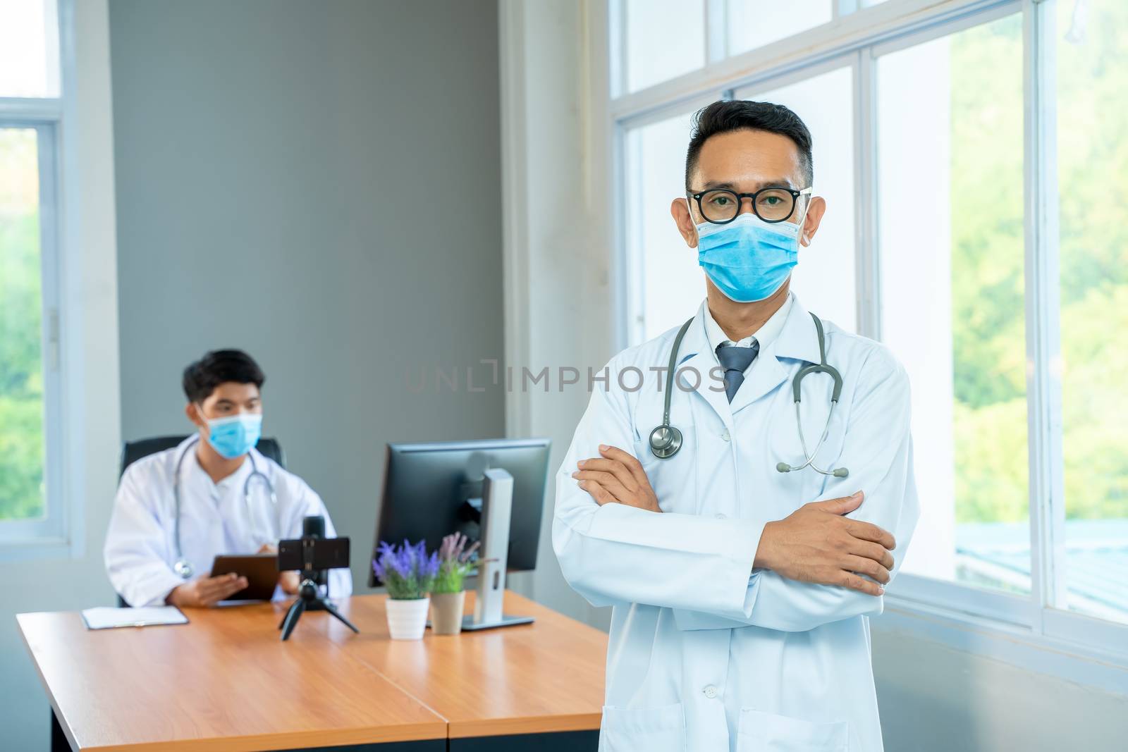Doctor wearing medical mask standing in hospital. by Visoot