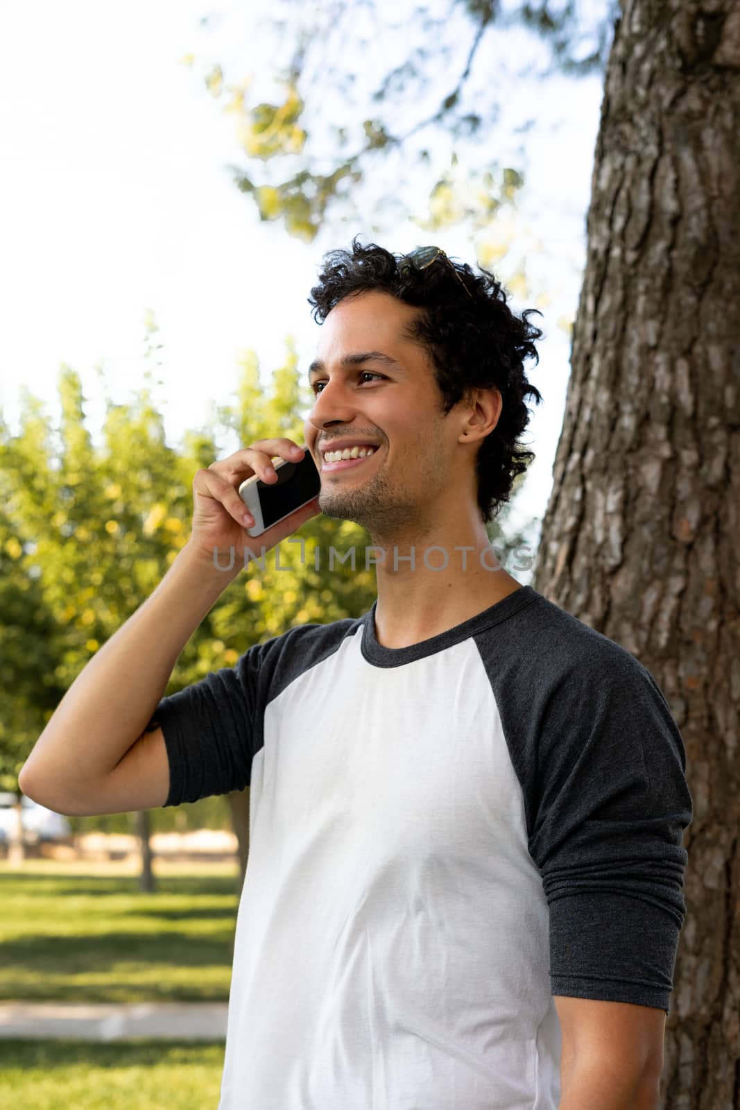 Portrait of handsome young man using his mobile phone outside