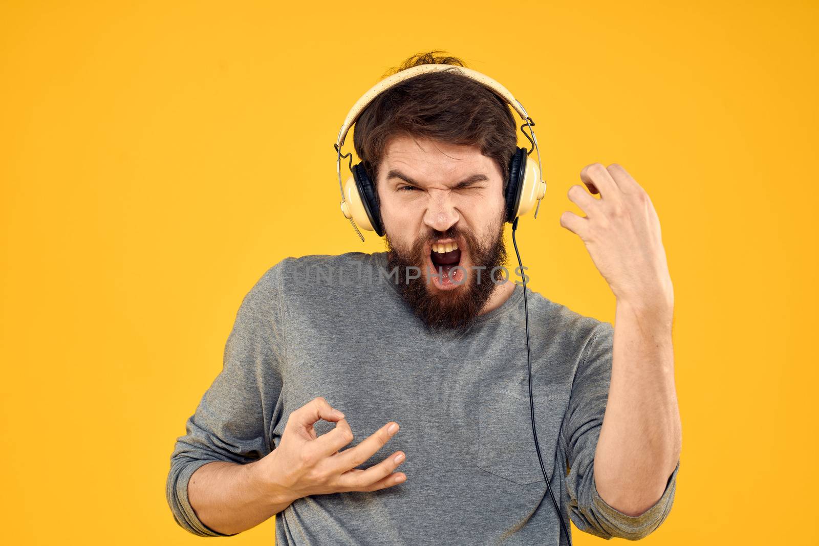 Man with headphones music lifestyle lifestyle technology yellow background. High quality photo