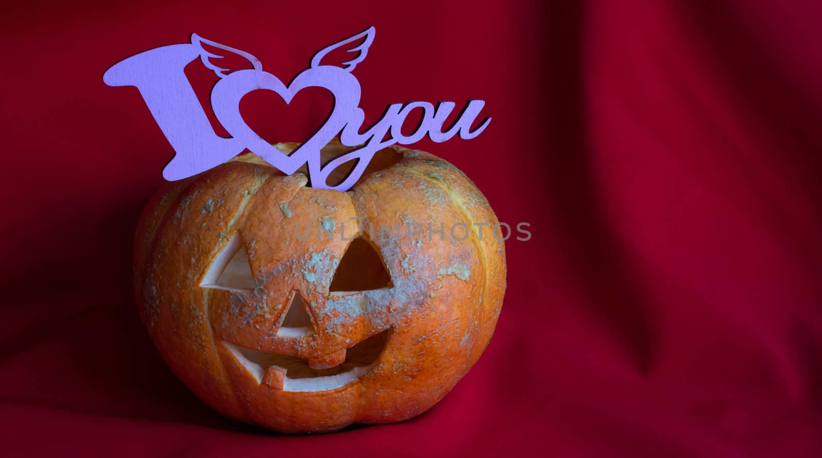 Halloween.pumpkin lantern with the sign, I love on a red background