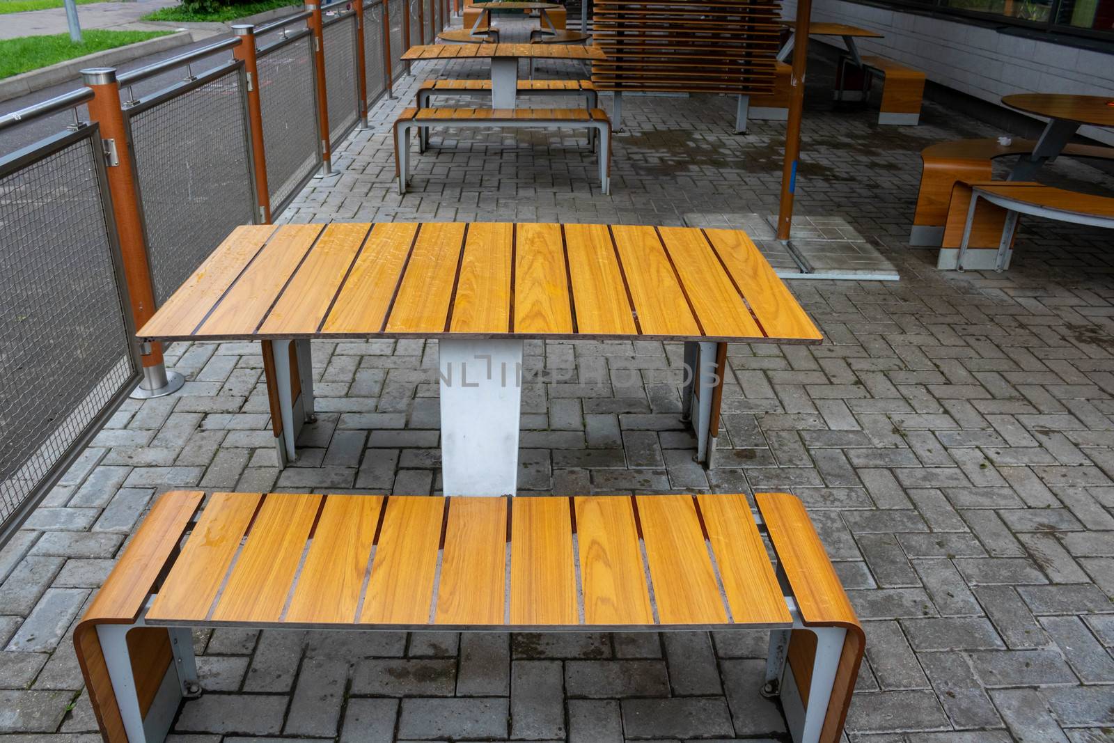 Light brown table, open roadside cafe on an autumn day.