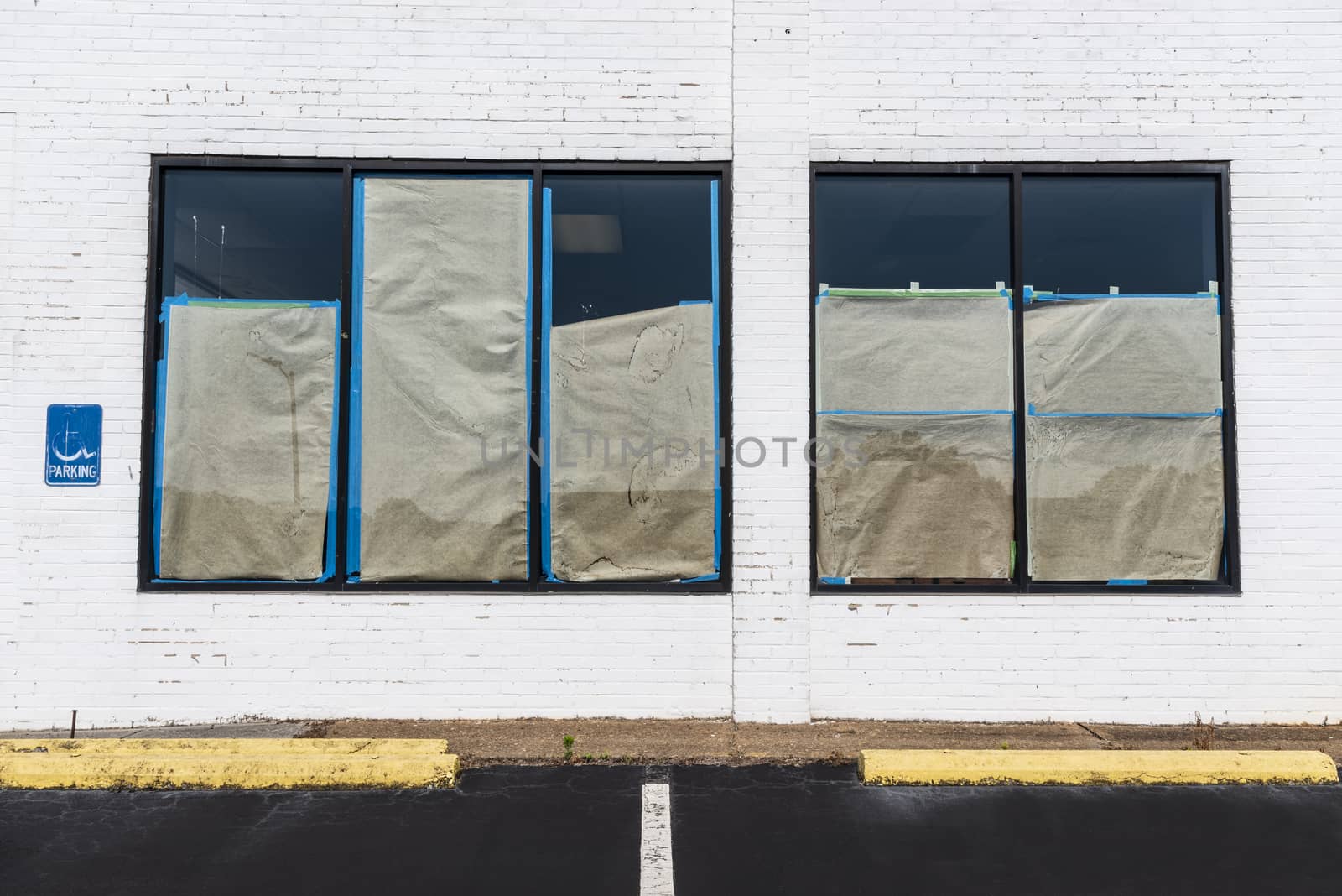 Horizontal shot of a boarded up bankrupt retail shot after the Pandemic.