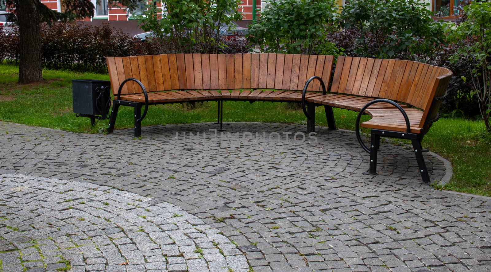 Brown semi-circular bench in the autumn Park.