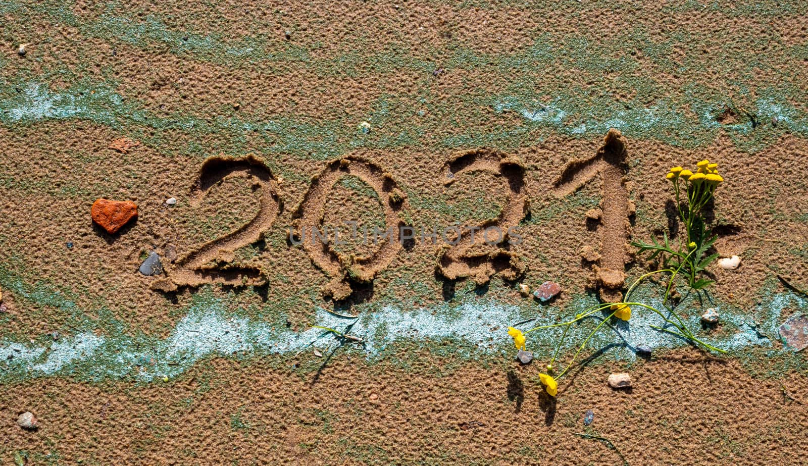 The concept of a New year. Heart and numbers 2021 in the sand. Summer beach holidays . The message is handwritten by lapushka62