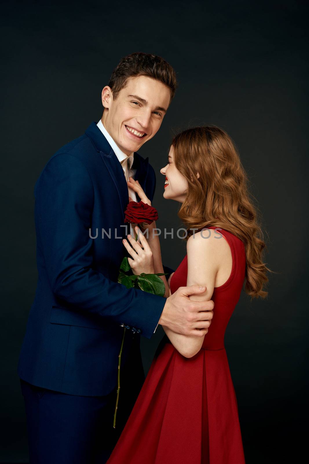 luxury couple hug romance relationship rose over dark isolated background. High quality photo