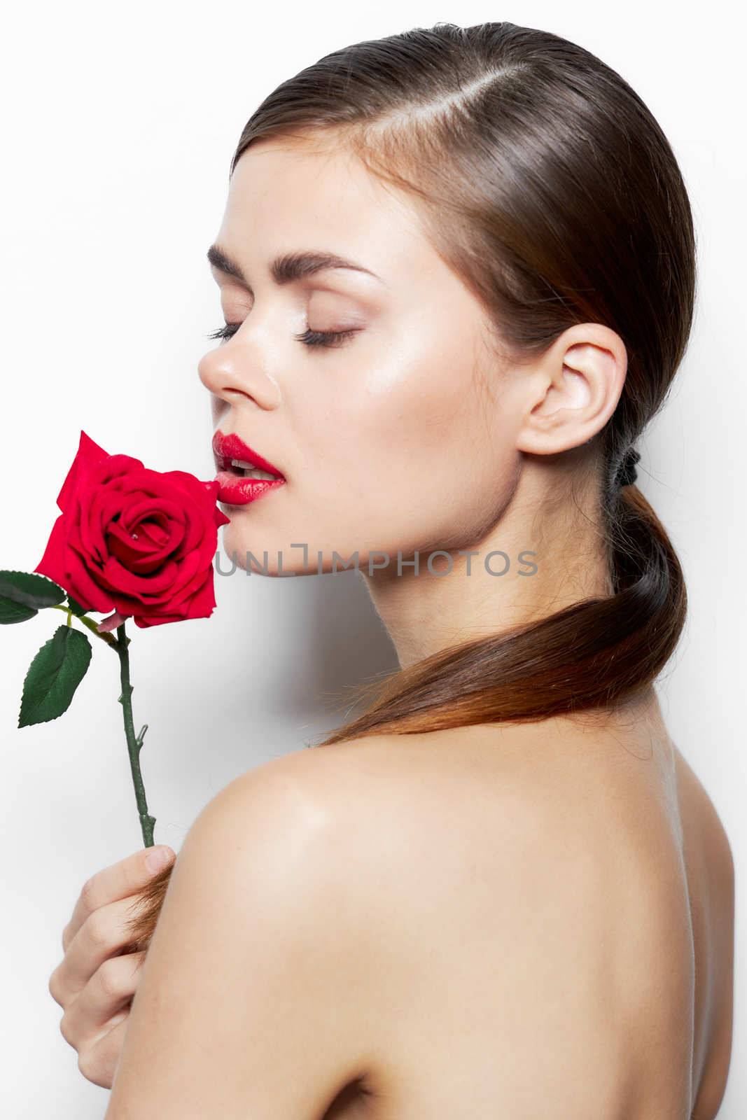 Lady with rose Closed eyes flower near the face makeup background