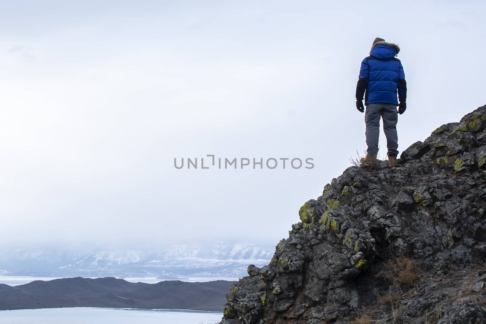 Happy man standing on cliff, man looking at landscape view by cuckoo_111