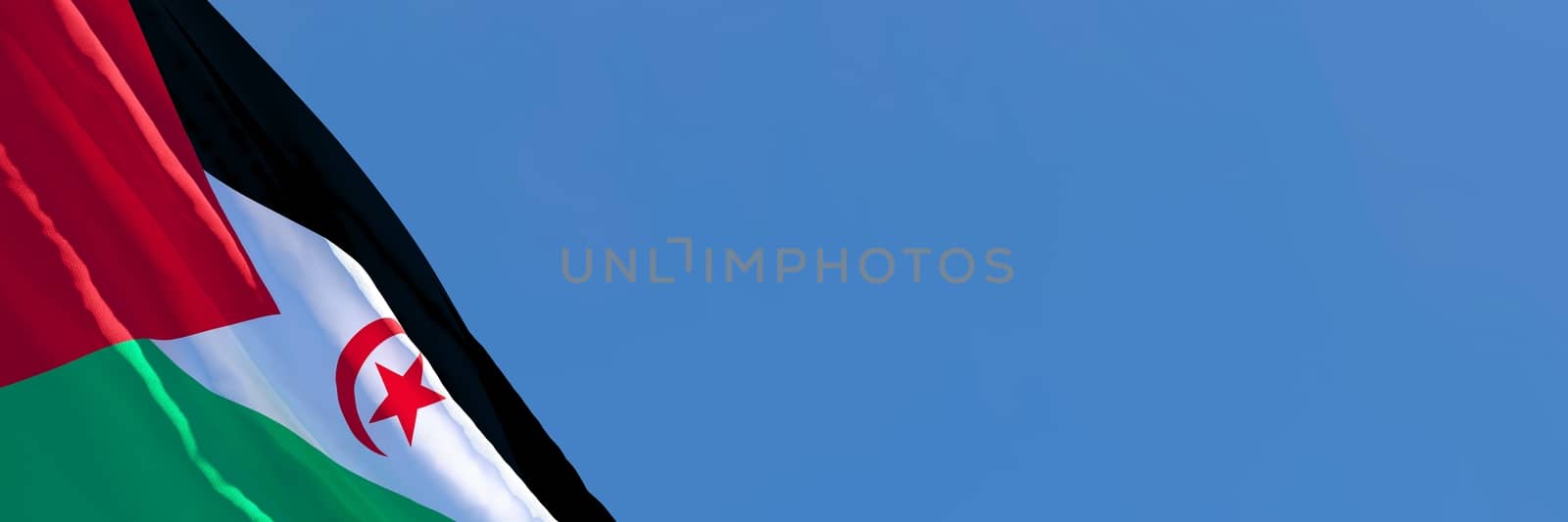 3D rendering of the national flag of Sahrawi Arab waving in the wind against a blue sky