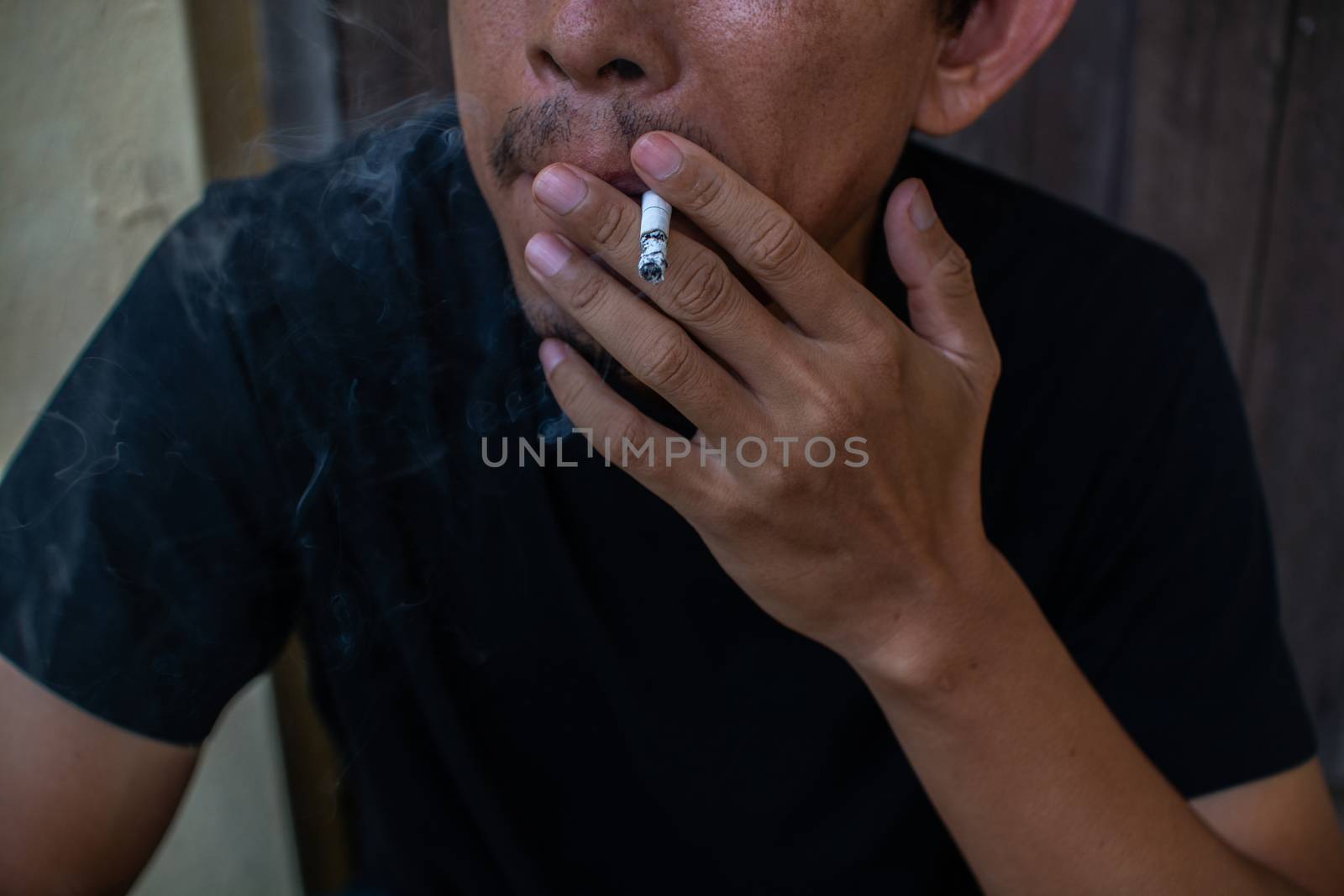 Man smoking cigarette, close-up photography