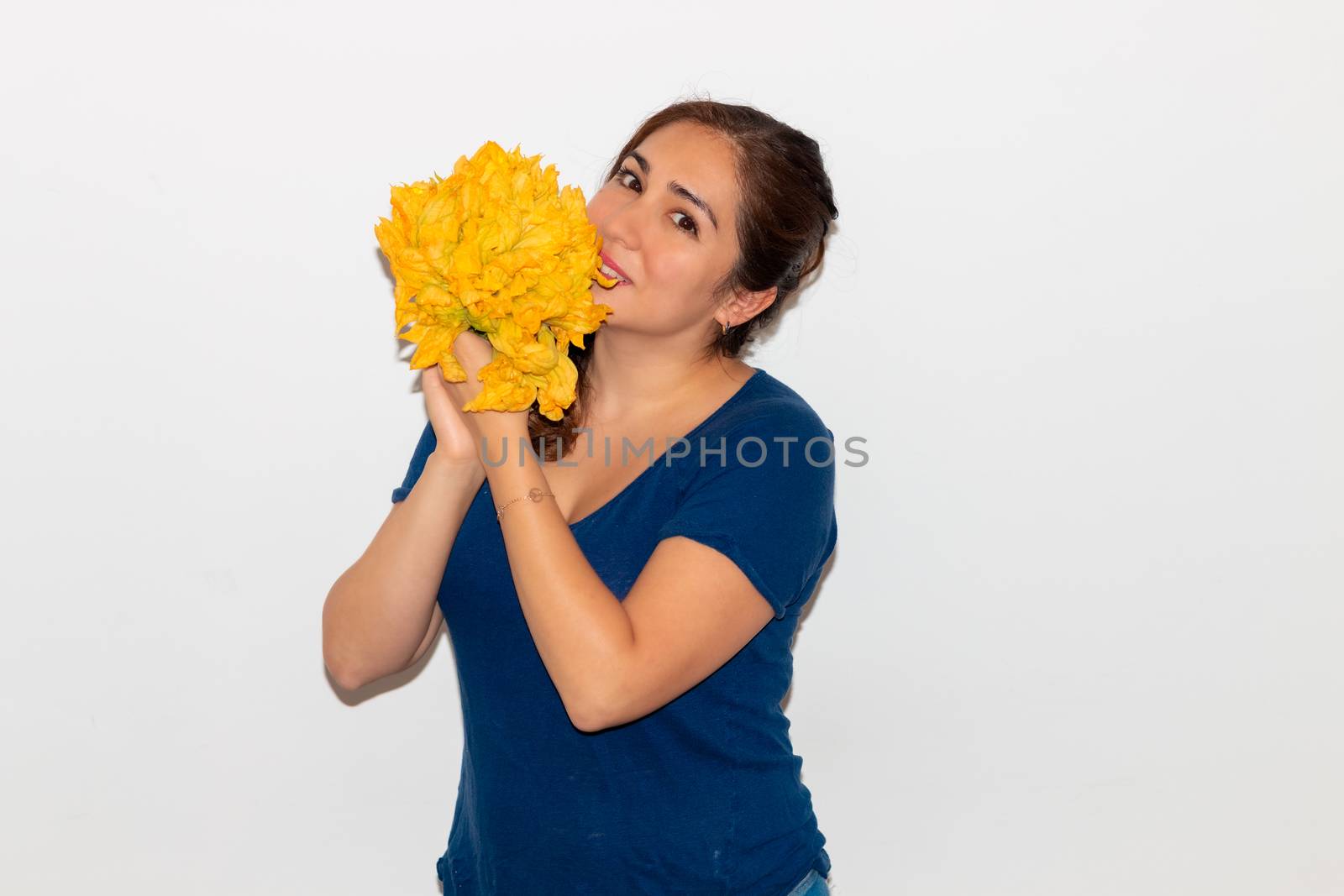 Real young man with a bunch of pumpkin flower. Isolated on a white background. Copy space