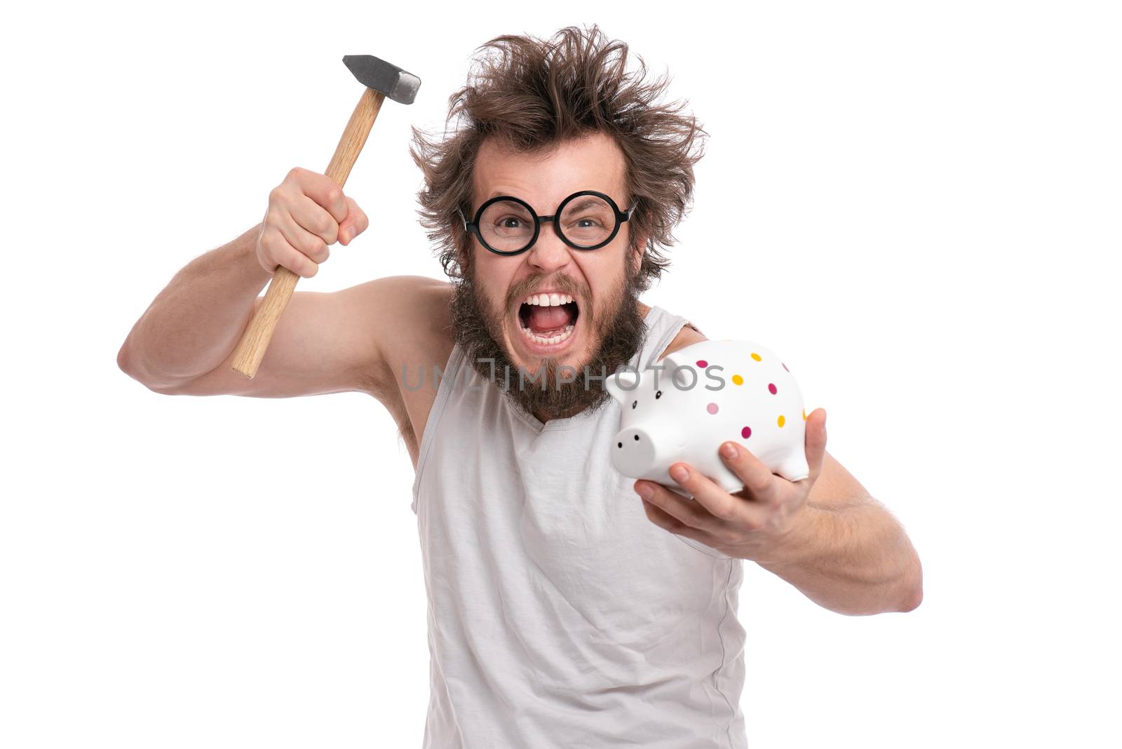 Crazy bearded Man with funny Haircut in eye Glasses holding Piggy Bank and Hammer, isolated on white background. Saving Money concept. Male about to break piggybank.