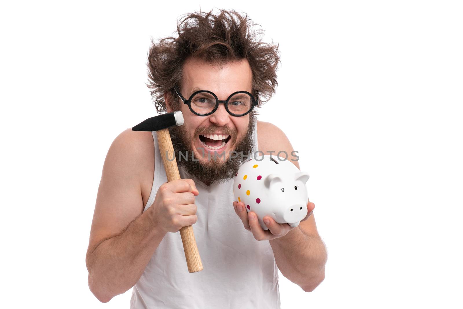 Crazy bearded Man with funny Haircut in eye Glasses holding Piggy Bank and Hammer, isolated on white background. Saving Money concept. Male about to break piggybank.