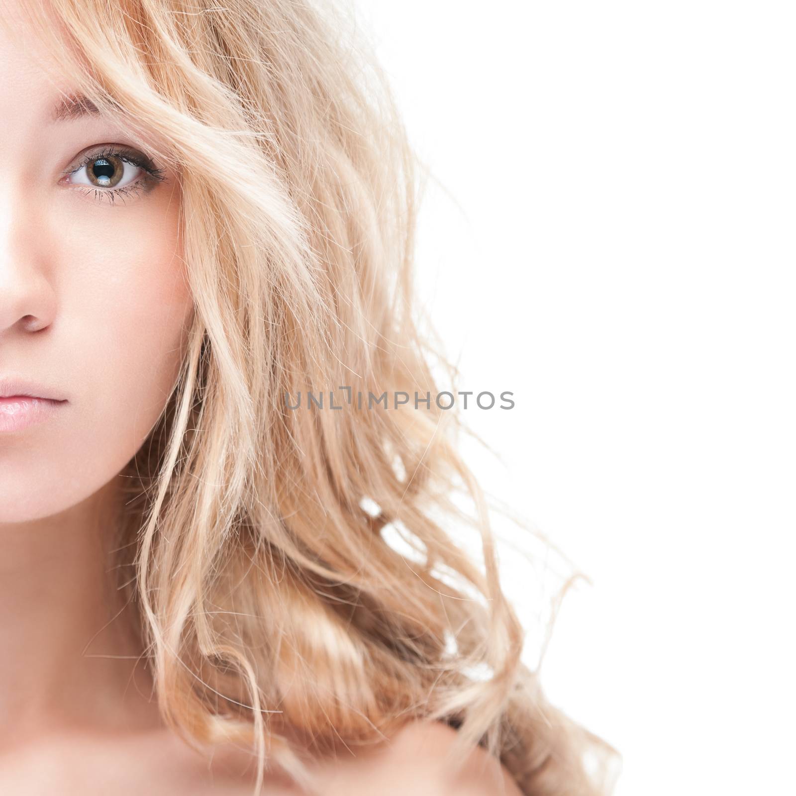 Sensual portrait of young beautiful blonde woman on white background. Sexy topless girl with curly hair looking passionate and tempting. Youth, pure natural beauty and passion.