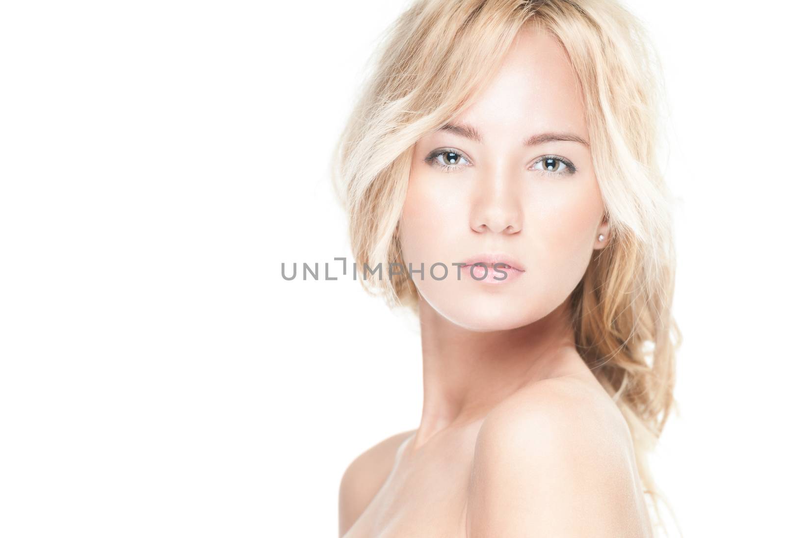 Sensual portrait of young beautiful blonde woman on white background. Sexy topless girl with curly hair looking passionate and tempting. Youth, pure natural beauty and passion.