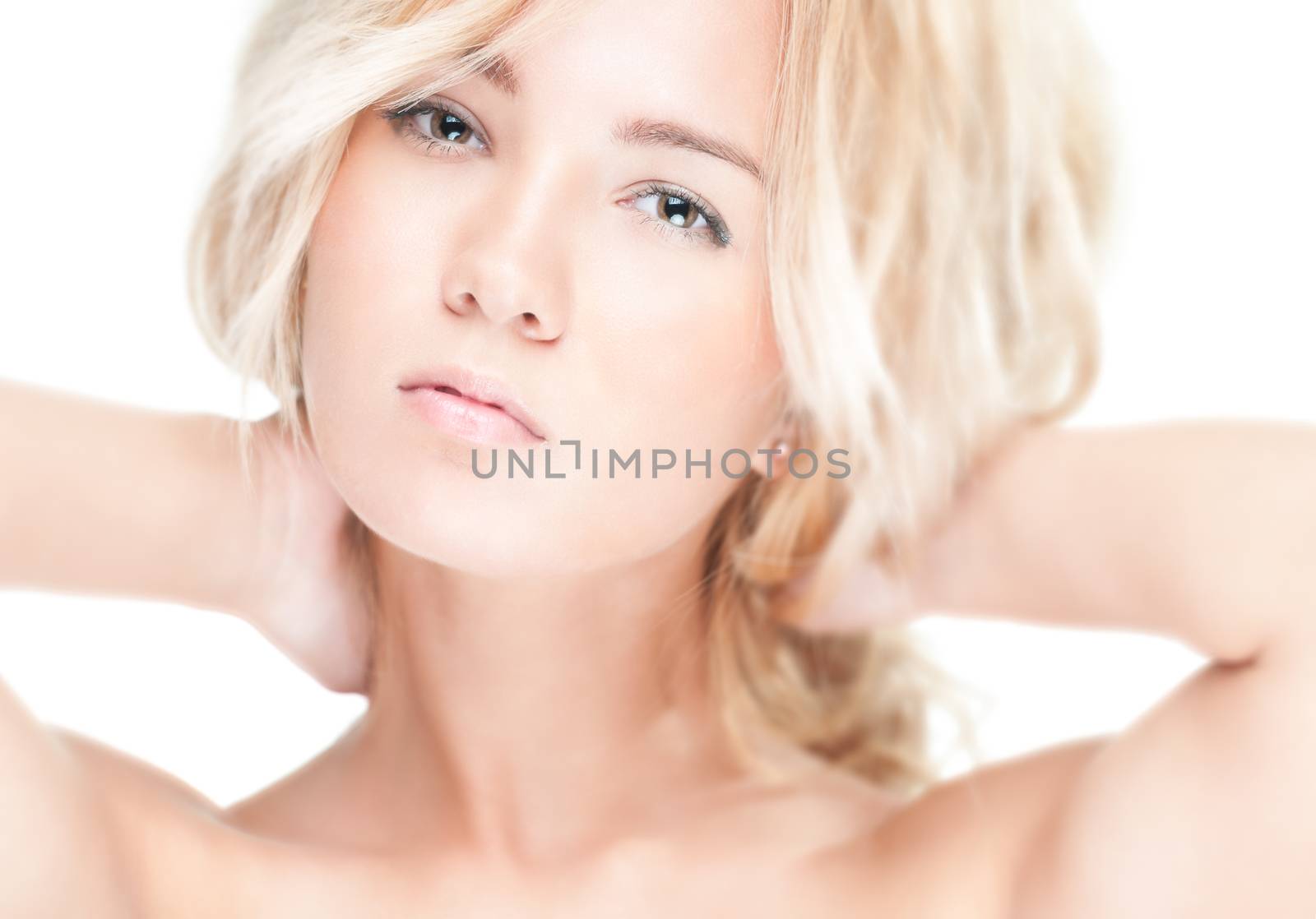 Sensual portrait of young beautiful blonde woman on white background. Sexy topless girl with curly hair looking passionate and tempting. Youth, pure natural beauty and passion.